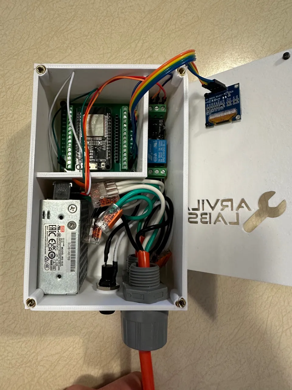 The WiFi Monitor opened up, showing the ESP32 board, relay, power supply, and wiring inside.